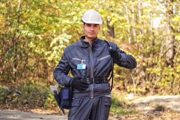 Cable guy holding optical cable and pointing at you