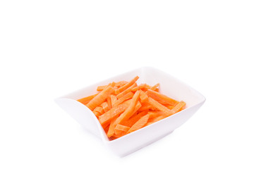 fresh grated carrots on a plate isolated on white background