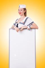 Woman sailor with blank board on white