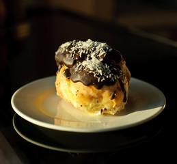 Eclairs with cream in chocolate coating