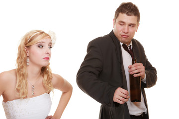 Wedding couple, bride with alcoholic drinking groom.