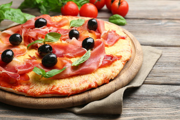 Delicious pizza served on wooden table