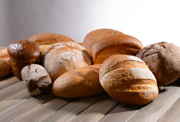 Fresh bread on table on white background