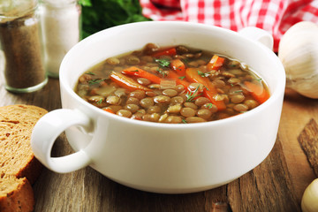Delicious lentil soup on table close-up
