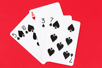 Individuality concept. Playing cards on red background
