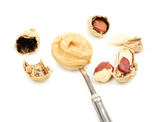 Creamy peanut butter in spoon, isolated on white