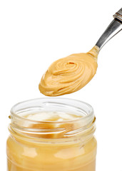 Creamy peanut butter in jar, isolated on white