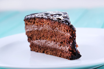 Delicious chocolate cake on plate on table close-up