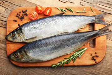 Fresh raw fish and food ingredients on table