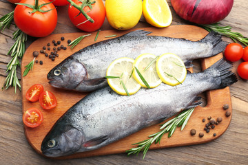 Fresh raw fish and food ingredients on table