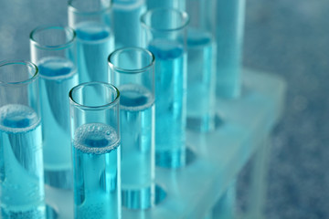 Test-tubes with liquid on color background