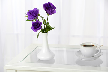 Beautiful bouquet of flowers in vase on window background