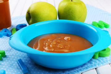 Fresh baby food in bowl with spoon