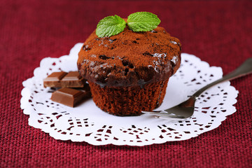 Yummy chocolate cupcake on table