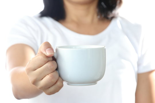 Woman Holding A White Coffee Cup,in A Gesture Of Giving.