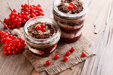 Delicious dessert in jars on table close-up