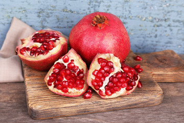 Juicy ripe pomegranates on old wooden table
