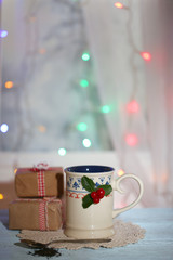 Christmas composition with cup of hot drink, on wooden table