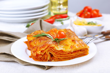 Portion of tasty lasagna on table