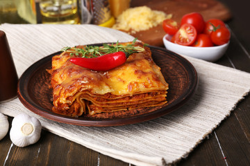 Portion of tasty lasagna on table