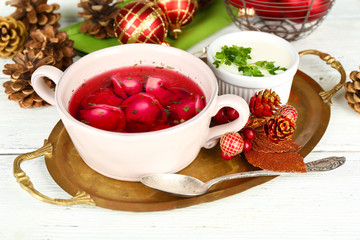 Traditional polish clear red borscht with dumplings and