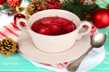 Traditional polish clear red borscht with dumplings and