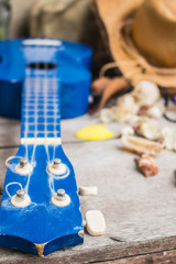 Ukulele and fabrics  on table.