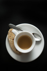  Hot espresso with cookie on black
