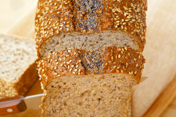 Cutted rye bread loaf on wooden table