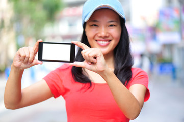 young asian woman on the phone walking at shopping street