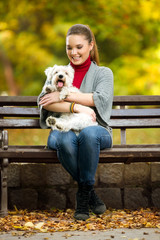 girl and her dog maltezer in a park