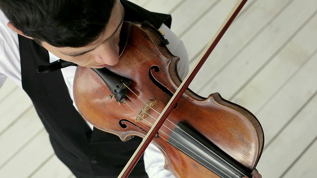 Latino violinist man on a white background.