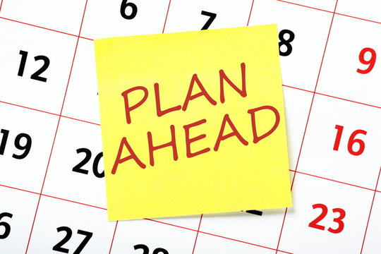 The phrase Plan Ahead written on a yellow sticky note