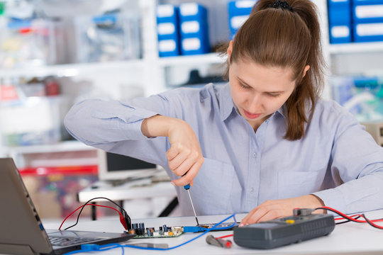 girl student studying electronic device with a microprocessor