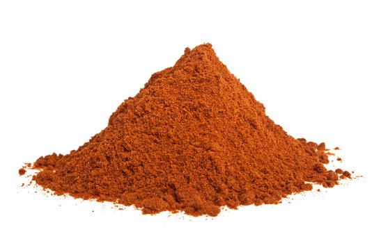 Powdered red pepper pile on white background
