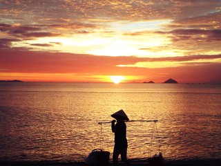 Naklejka na ściany i meble silhouette of vietnamesse at sunset