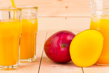 Mango Juice on the wooden background isolated.