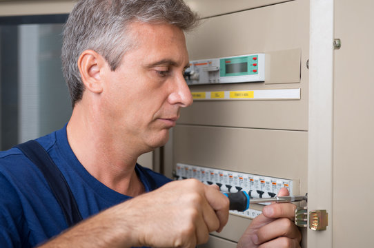 Electrician Repairing A Circuit Breaker