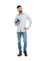 Naklejka premium Young bearded smiling man with books in hands on white