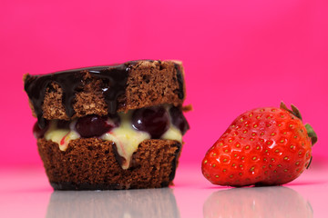 Chocolate cake on white plate with a strawberry