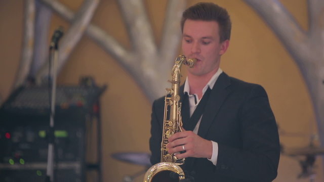 Saxophone player performs on stage.