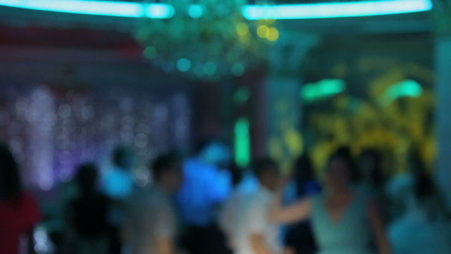 People dancing at a disco in blur