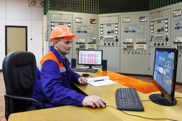 Engineer watching parametrs on monitor
