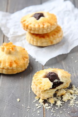 Homemade shortbread cookies with chocolate on wooden background