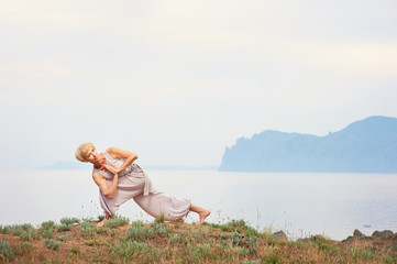 Senior woman doing yoga exercises