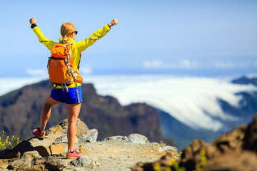 Hiking success, happy woman in mountains