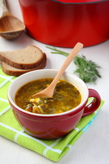Fresh  green vegetable soup in the red bowl