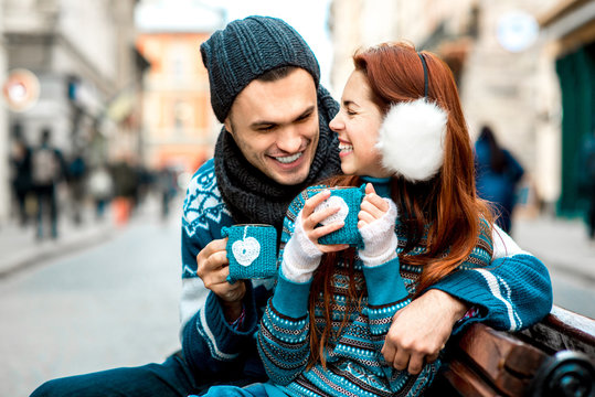 Young Couple With Coffee In Winter Outside