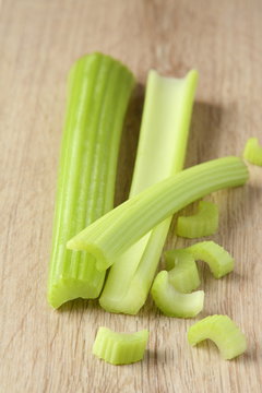 Fresh celery stems on a wooden background