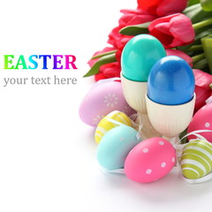Colorful easter eggs and pink tulips over white with sample text
